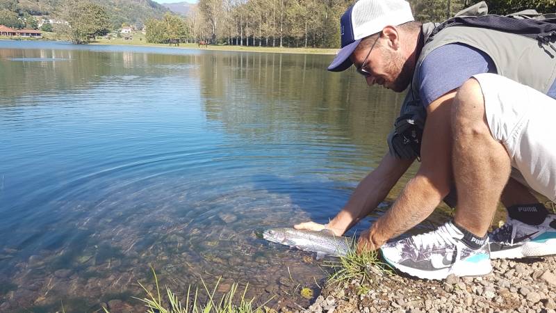 Fly fishing for trout on lake in Cantal