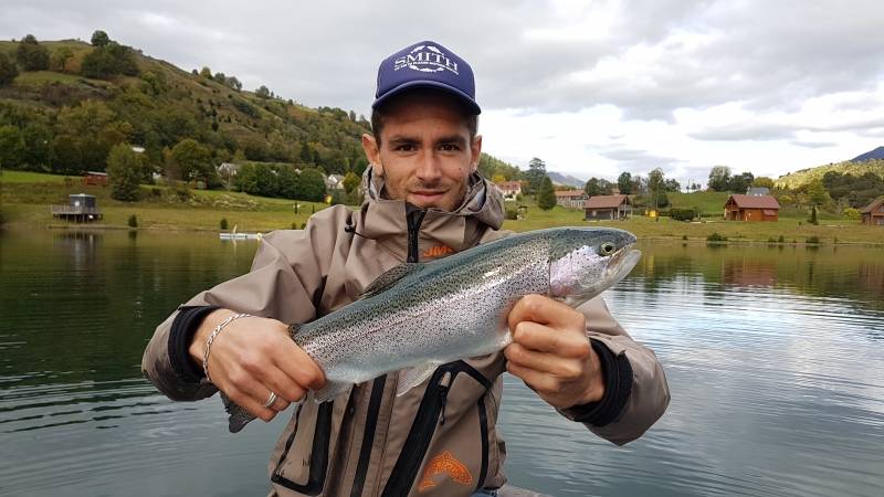 Fly fishing for trout on lake in Cantal